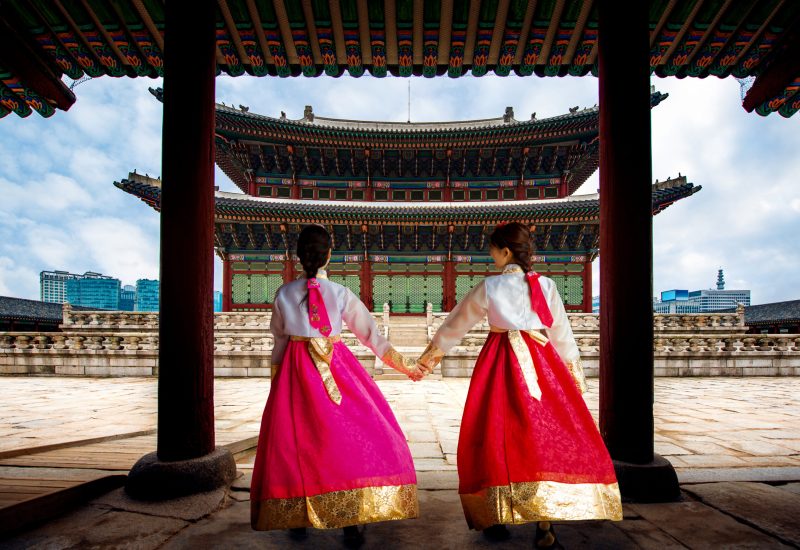 Korean lady in Hanbok or Korea gress and walk in an ancient town and Gyeongbokgung Palace in seoul, Seoul city, South Korea.